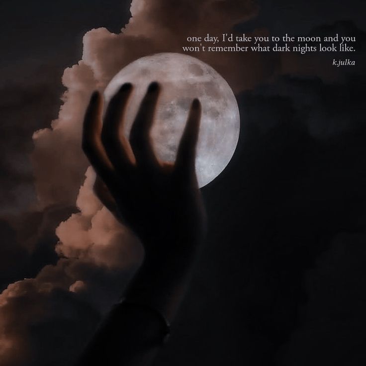 a person's hand reaching up into the sky with a full moon in the background