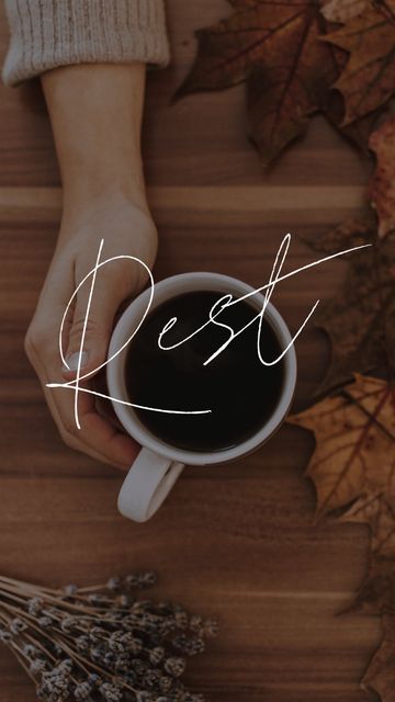 a person holding a cup of coffee with the word rest written in white on it