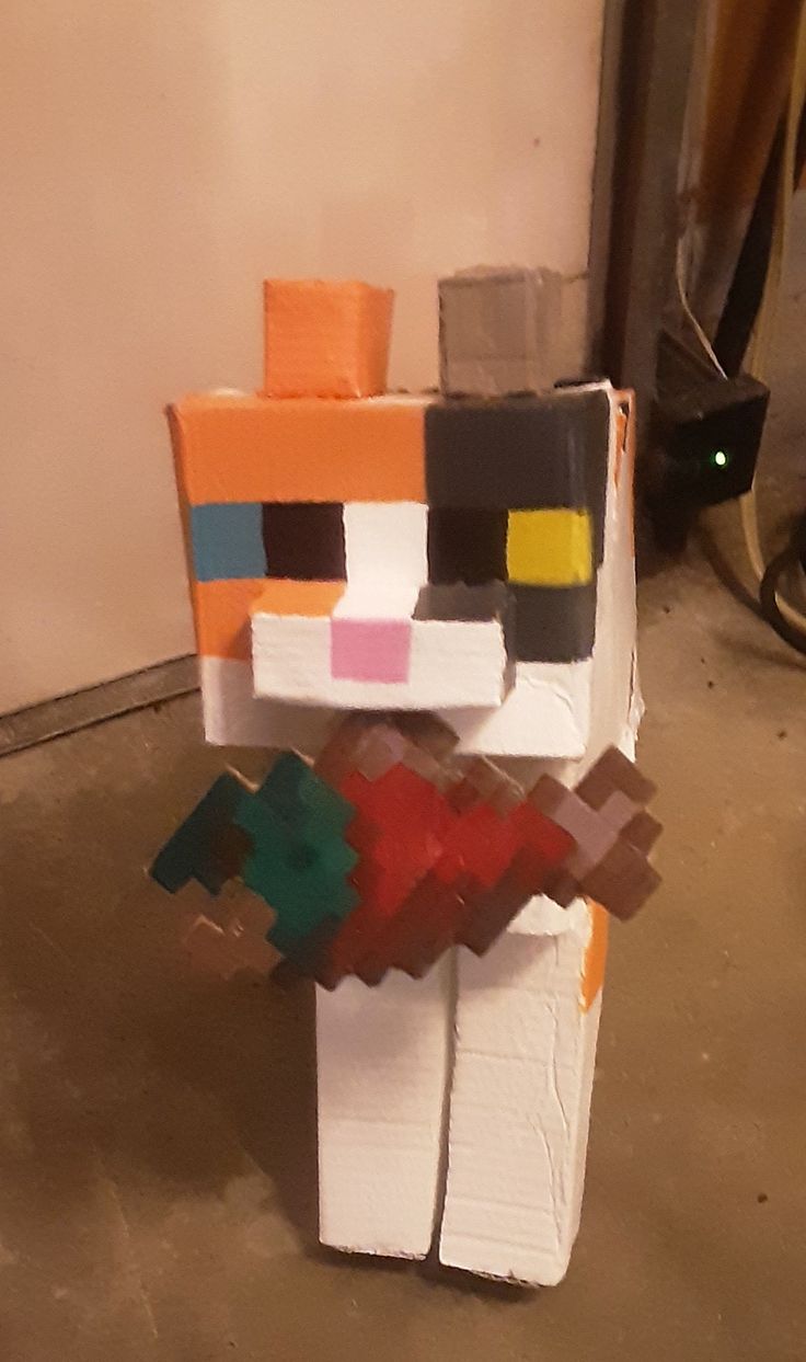 a paper mache made to look like a person with different colored blocks on it