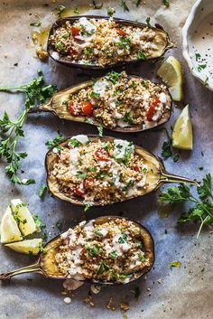 three stuffed eggplant boats filled with rice and vegetables