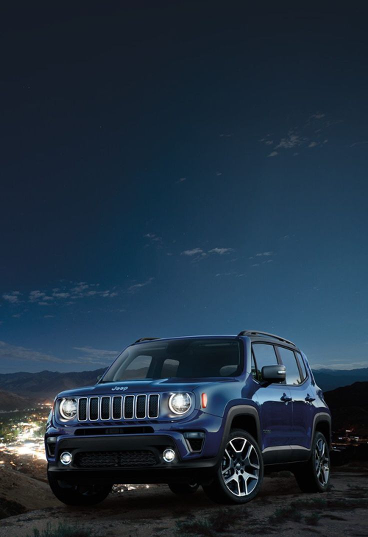 a blue jeep parked in the desert at night