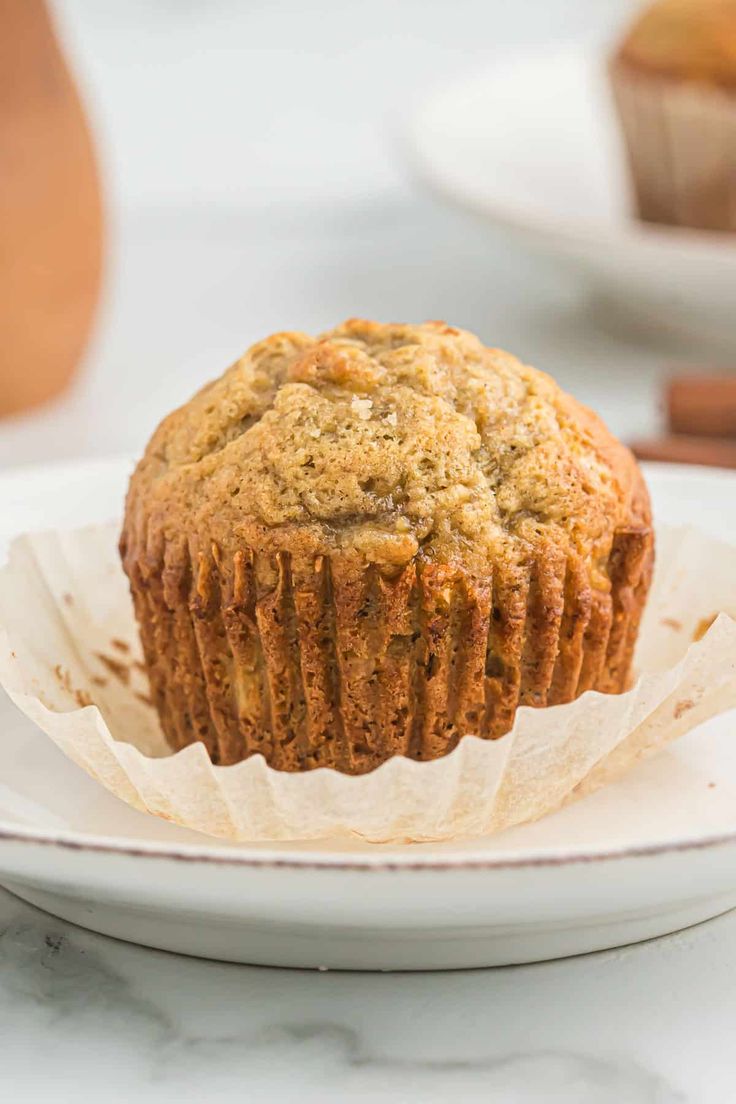 a muffin sitting on top of a white plate