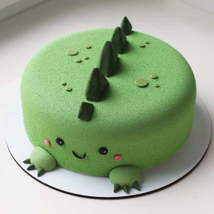 there is a green cake that looks like a frog