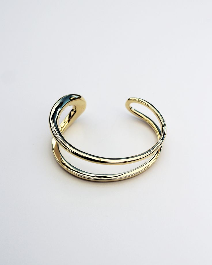 The Formation Wrist Cuff is an essential styling piece. Based on the shape of our Organic Long Hoops and wrapped into a modern wrist cuff form, this is a timeless piece that will elevate any outfit. Wear it with other styles from our core collection. DETAILS: High micron, ethically sourced 18K gold certified by LBMA Responsible Gold to meet international ethics standards. Eco brass base metal with 18K gold plating or solid 925 sterling silver. 6 months warranty Nickel free. Packaged in F+H brand Elegant Double Band Gold Cuff Bracelet, Elegant Gold Double Band Cuff Bracelet, Modern Gold Double Band Cuff Bracelet, Modern Gold Open Cuff Bracelet, Modern Adjustable Cuff Bracelet For Formal Occasions, Timeless Gold Open Cuff Bracelet, Modern Yellow Gold Open Cuff Bangle, Elegant Open Band Cuff Bracelet, Modern Yellow Gold Cuff Bracelet With Oyster Design