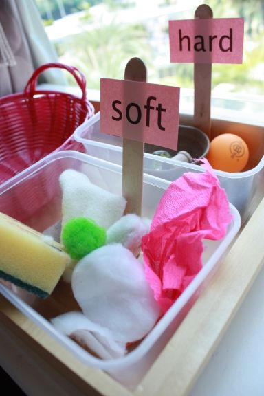 a plastic container filled with lots of different types of items next to a sign that says hard and soft