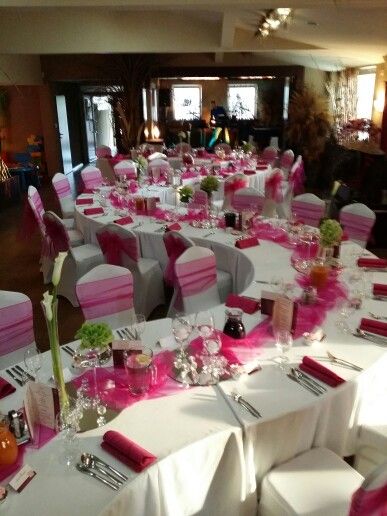 the tables are set with pink and white linens for a wedding or special event