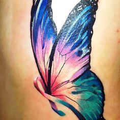 a colorful butterfly tattoo on the back of a woman's stomach