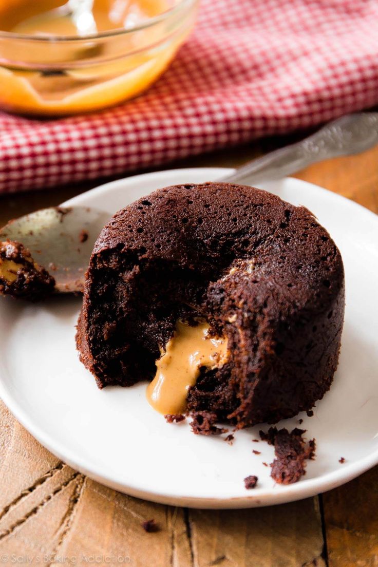 a piece of chocolate cake on a plate with a bite taken out of the middle