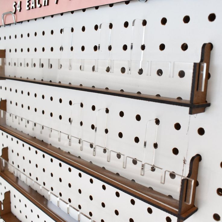 three rows of pegboard with holes on them