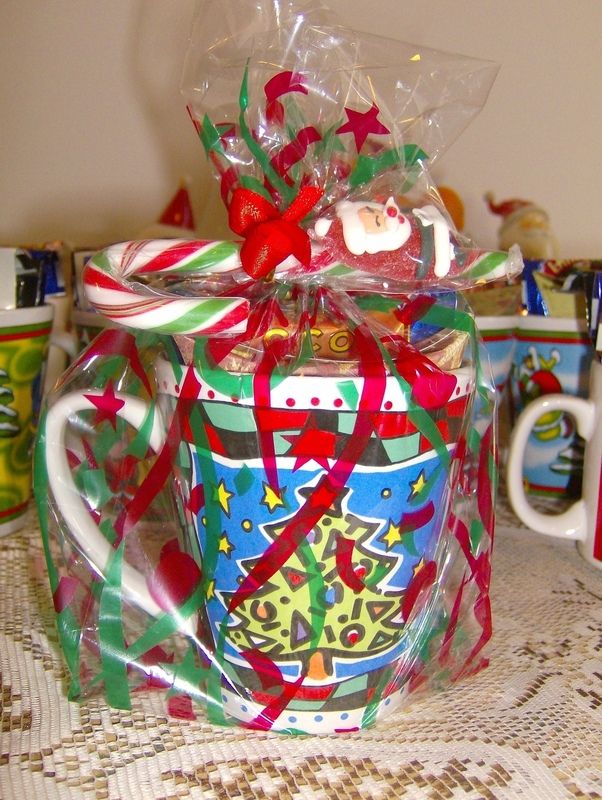 there is a coffee mug wrapped in plastic and decorated with candy canes on the table