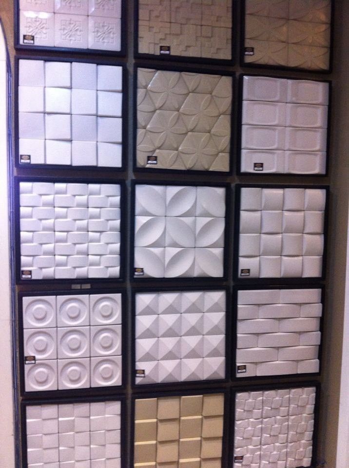 a display case filled with lots of white and brown tile tiles on top of each other