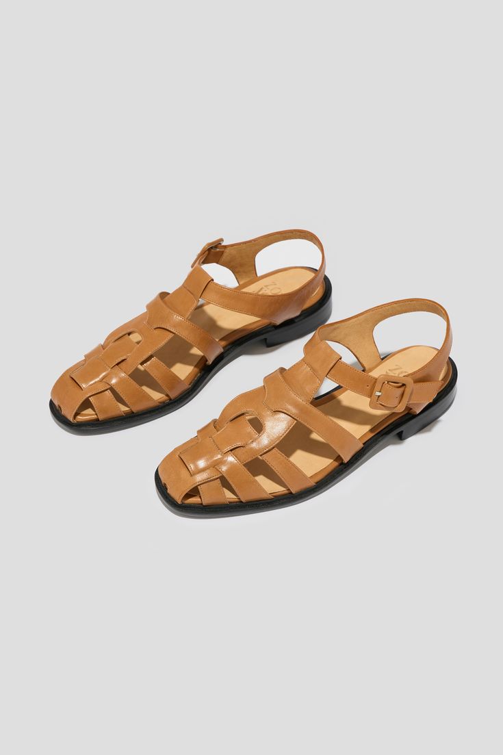 We could go on and on about the merits of owning a closed-toed flat sandal. The Franca is ideal as a foundational late-spring, summer & early fall shoe both for its comfort and its ability to transition well from office to off-duty. The Franca is a sleek and feminine take on the fisherman sandal crafted from interlocking pieces of leather and set on a 20 mm stacked leather heel. This pair has been crafted from tan kidskin leather and a matching buckle, finished on a contrasting black outsole. St Fall Shoe, Late Spring, Loafer Mules, Early Fall, Fall Shoes, Flat Boots, Heeled Loafers, Boot Sandals, Off Duty