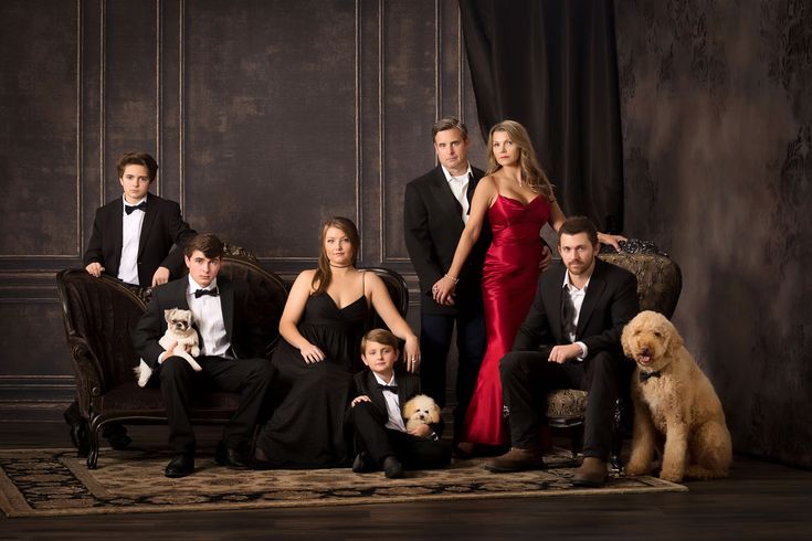 a group of people in formal wear posing for a photo with their dogs and cats