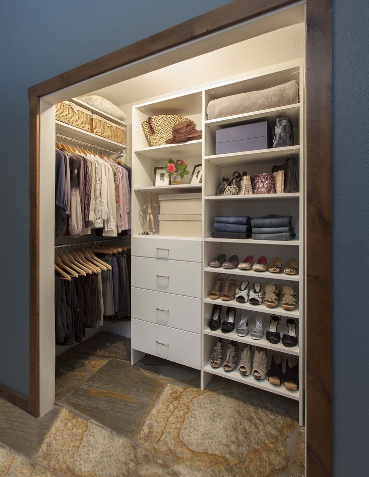 an open closet with shoes and other items