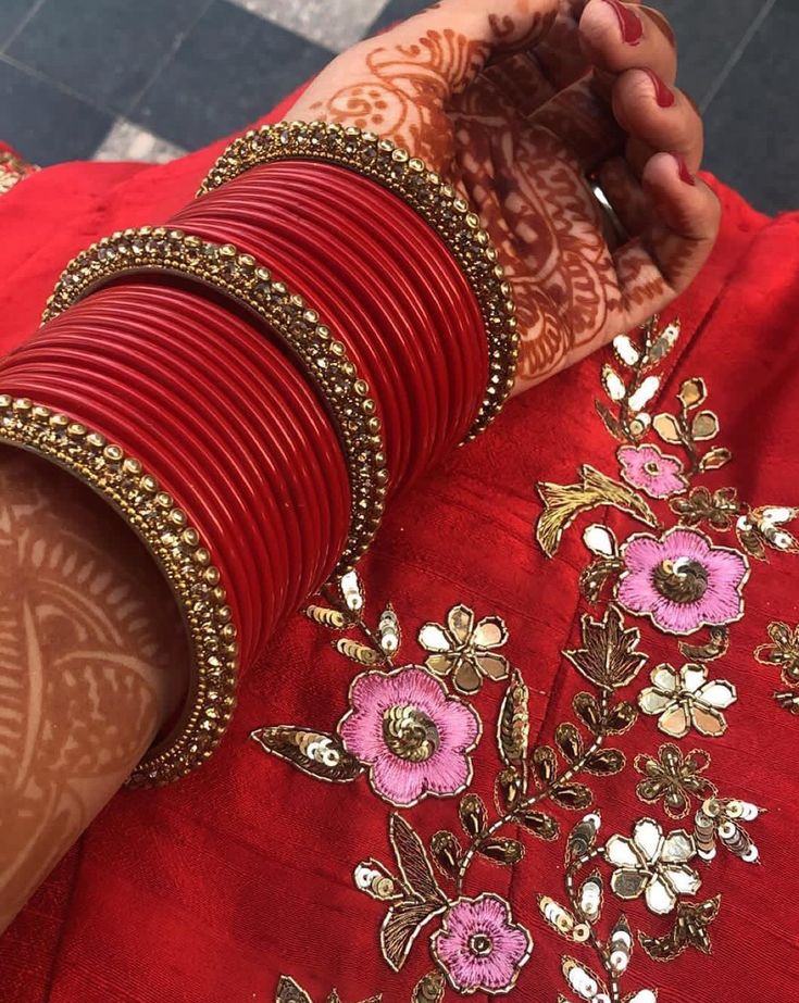 a woman with henna and bracelets on her arm