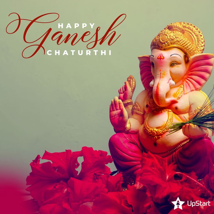 an elephant statue sitting on top of a pile of red flowers with the caption happy ganesh chaturthi