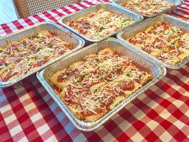 six pans of pizza on a table with red and white checkered cloth