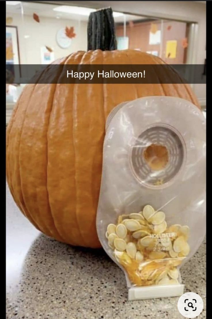 a plastic bag filled with nuts next to a pumpkin