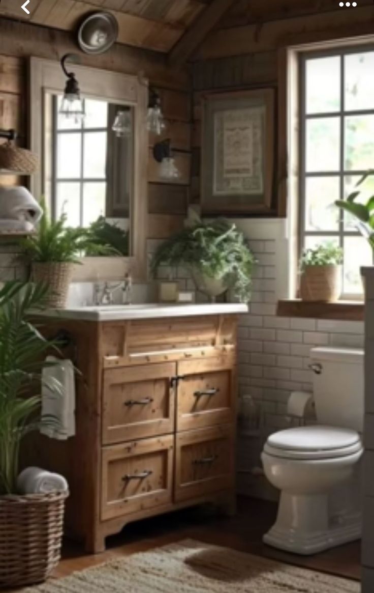 a white toilet sitting next to a sink in a bathroom under a window with potted plants