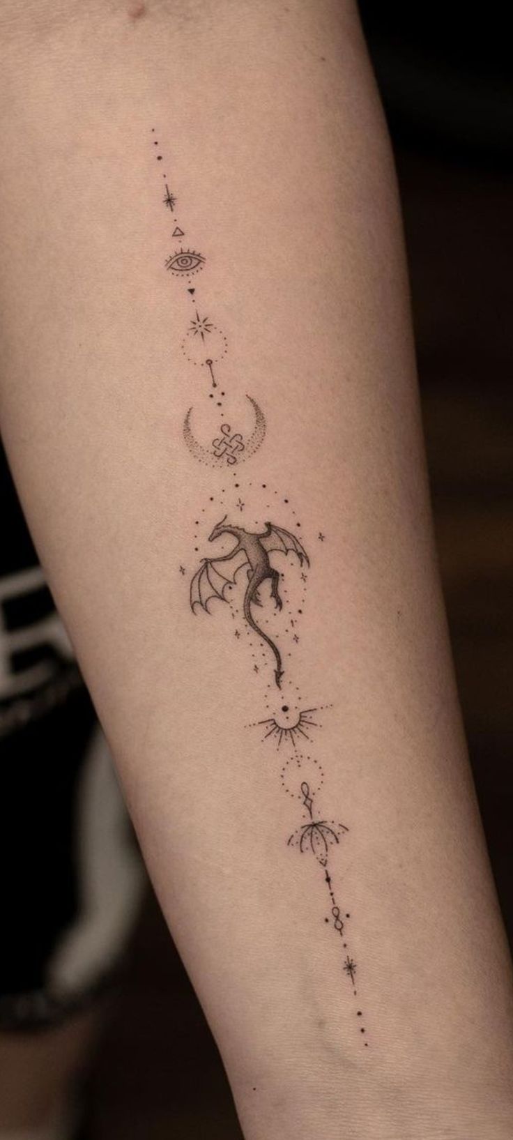 a woman's leg with a tattoo on it that has an arrow and stars