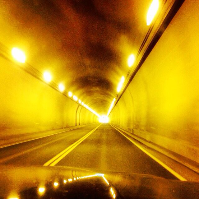 the inside of a tunnel with lights on