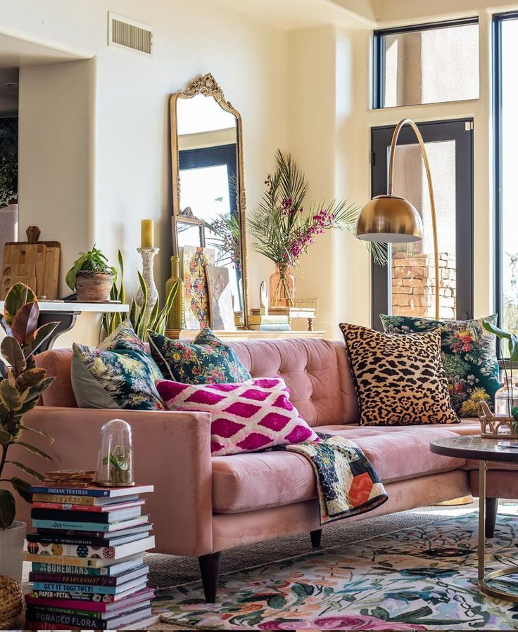 a living room filled with furniture and lots of plants on top of the couches