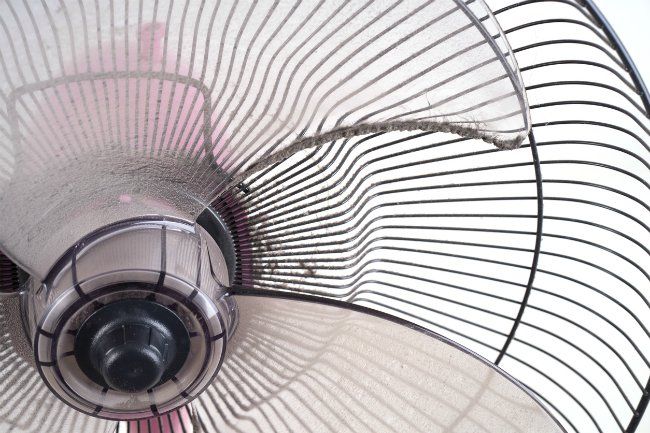 an aerial view of a metal fan with red and white lines on the blades,