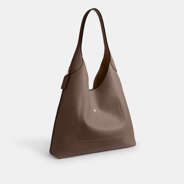 Our Brooklyn is an elegant minimalist silhouette—with a distinctly New York attitude. Crafted of natural grain leather with beautiful texture and soft feel this generously sized hobo style features a spacious interior with room for a 15” laptop and a snap pocket for access to essentials. The streamlined 39 is finished with a comfortable wide shoulder strap and an easy magnetic snap closure. | Coach Brooklyn Shoulder Bag 39 - Women's Purses - Brass/dark Stone Classic Hobo Bag With Smooth Grain And Double Handle, Timeless Everyday Shoulder Bag With Smooth Grain, Smooth Grain Hobo Bag In Tote Shape For Work, Smooth Grain Hobo Bag Tote For Work, Smooth Grain Tote Hobo Bag For Work, Modern Everyday Hobo Bag With Leather Lining, Smooth Grain Satchel Hobo Bag For Work, Workwear Satchel Hobo Bag With Smooth Grain, Modern Hobo Bag With Leather Lining For Everyday