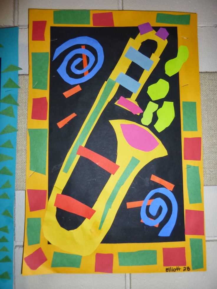 an art project made out of colored paper with a saxophone on the front and sides