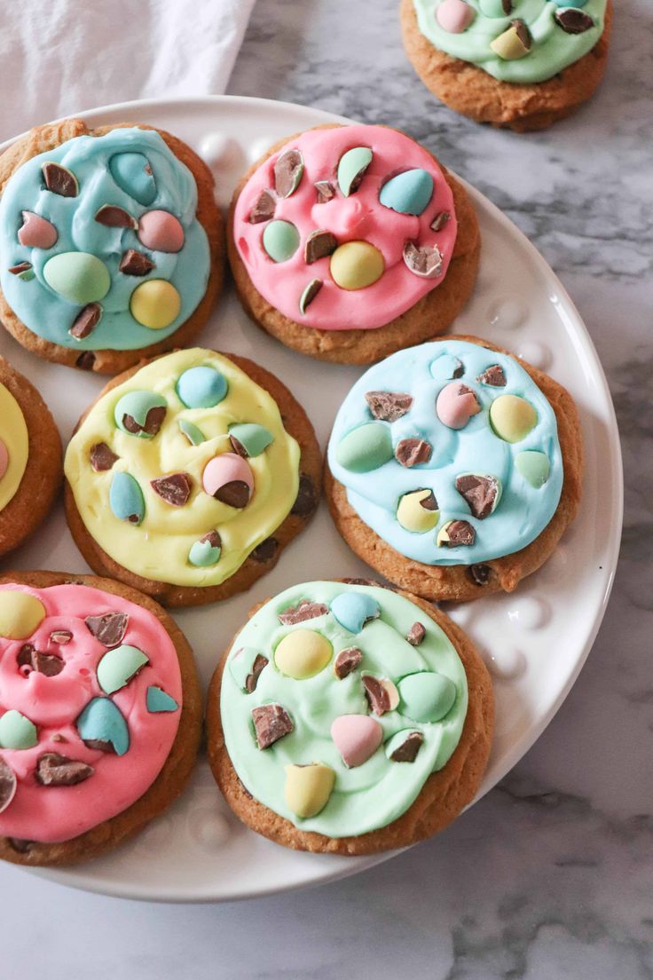 several decorated cookies on a white plate