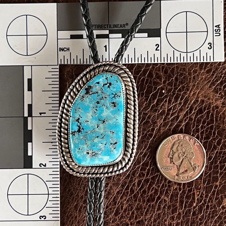 This Sleeping Beauty Turquoise is stunning & definitely makes quite the statement when worn! It is surrounded by heavy gauge double twisted sterling silver rope & is a substantial piece. It hangs beautifully on braided leather cord & has stamped sterling tips. A bolo tie is also sometimes called a shoestring necklace & is a part of everyday fashion accessories for both men & women today. They can be practical, tough and elegant. Wearing a bolo tie as a statement piece with your regular wardrobe Silver Western Jewelry With Adjustable Cord, Western Style Silver Jewelry With Adjustable Cord, Artisan Silver Jewelry With Adjustable Cord, Southwestern Silver Jewelry With Adjustable Cord, Adjustable Southwestern Jewelry With Large Stone, Western Style Engraved Blue Jewelry, Western Turquoise Jewelry With Patina, Blue Adjustable Hand Tooled Jewelry, Adjustable Southwestern Jewelry With Sterling Silver Clasp