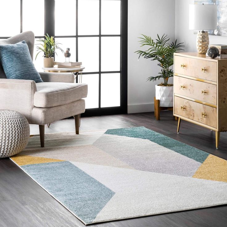 a living room with a couch, chair and rug