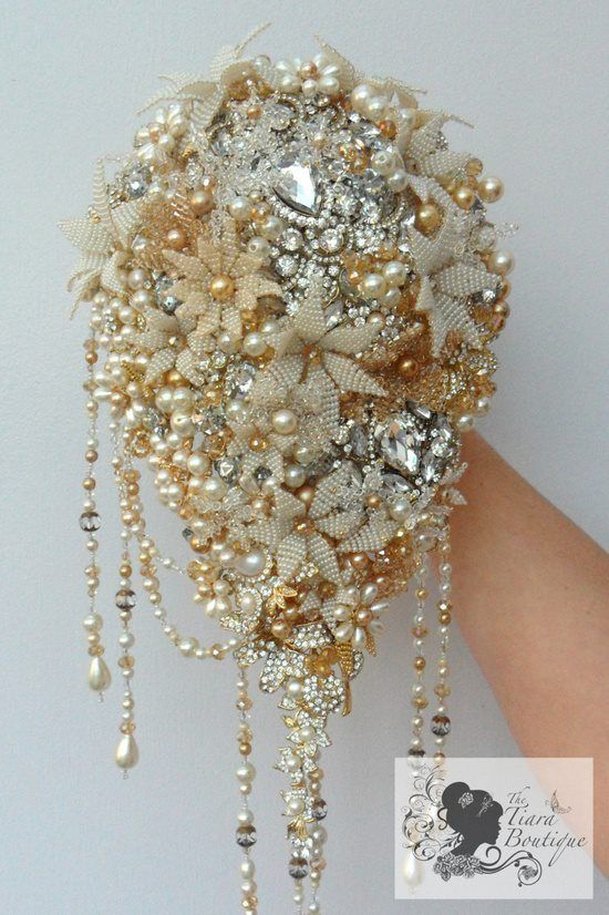 the brooch bouquet is made with pearls and other things that are attached to it