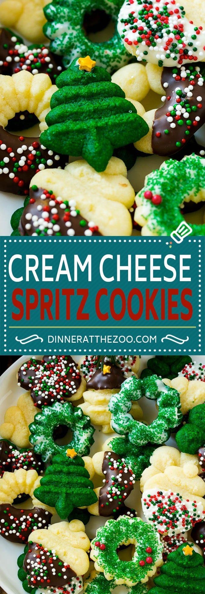 a white plate topped with cookies covered in green and red frosting next to a blue sign that says cream cheese spritz cookies