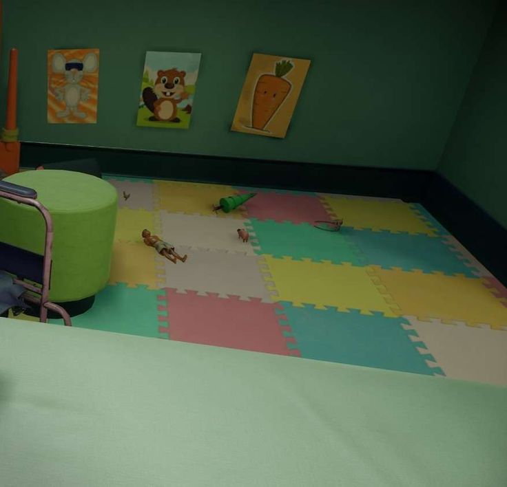 a child's room with green walls and toys on the floor