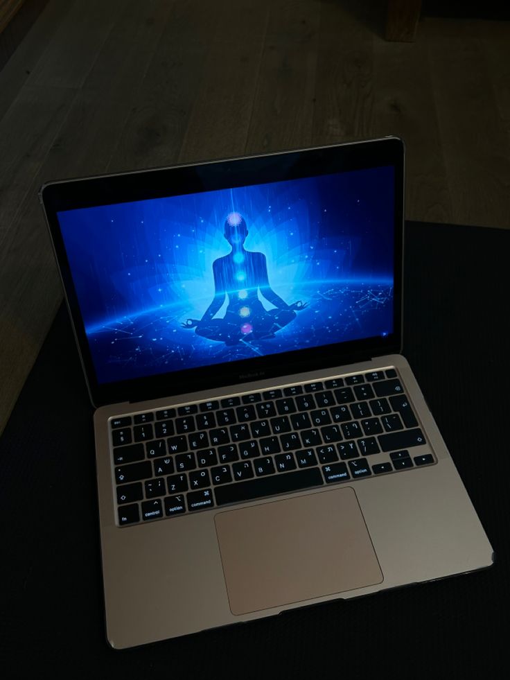 an open laptop computer sitting on top of a table