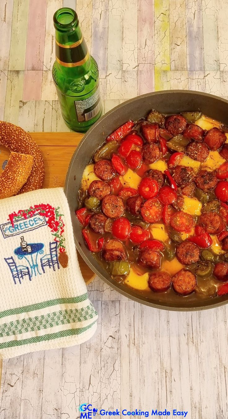 a pan filled with meat and vegetables on top of a table next to a napkin