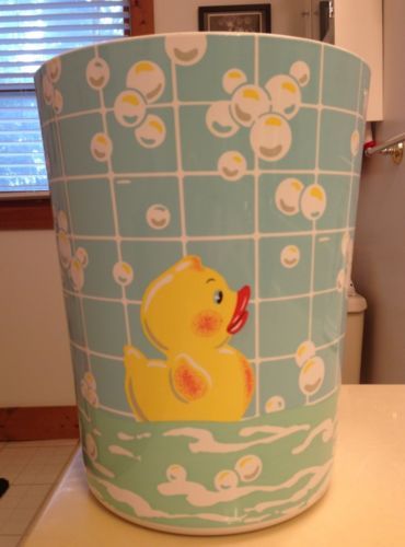 a yellow rubber ducky bath tub sitting on top of a bathroom counter next to a window