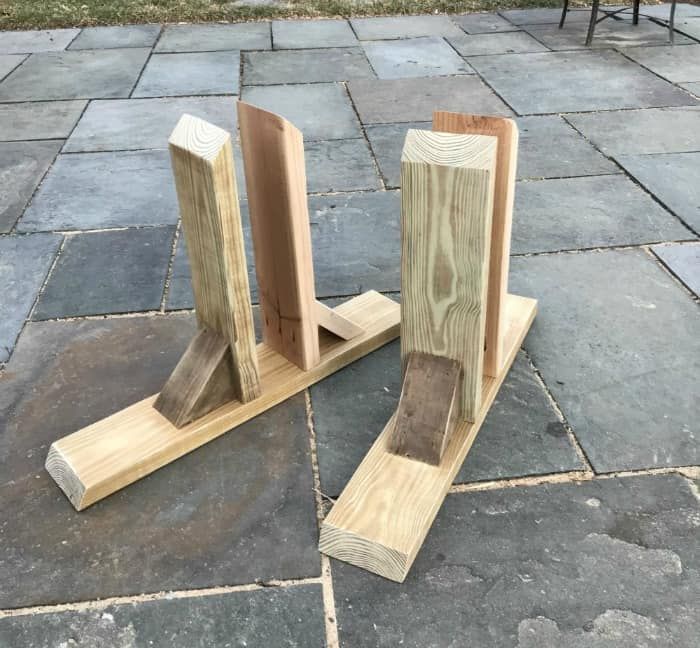 two pieces of wood sitting on top of a stone floor next to eachother