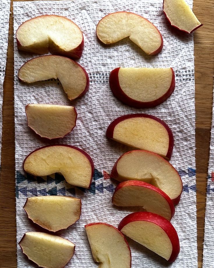 sliced apples sitting on top of a piece of paper