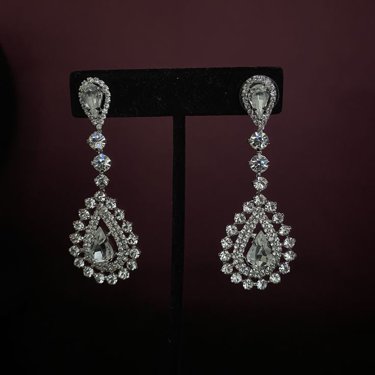 Our MARQUISE Earrings with Swarovski Crystals are Absolutely Stunning. MARQUISE Drop Bridal Earrings can add glitter and glamour to your amazing special day. Handcrafted Unique Design Highest Quality & Finest Materials Brilliant SWAROVSKI Crystals Cubic Zirconia Rhodium / Platinum plated gives a luxurious shine and luster. It has a brilliant silver tone and guards against scratches and tarnish. Earrings Drop Length is approx. 2.25 in (5.7 cm) FREE Shipping in USA. If Out of Stocks or made to Luxury Diamond Crystal Earrings For Wedding, Elegant Teardrop Crystal Embellished Earrings, Luxury Teardrop Bridal Earrings With Cubic Zirconia, Luxury Teardrop Bridal Earrings In Cubic Zirconia, Luxury Rhinestone Wedding Earrings, Formal Crystal Cluster Earrings With Sparkling Stones, Luxury Rhinestone Earrings For Wedding, Formal Crystal Earrings With Diamond Accents, Elegant Crystal Embellished Bridal Earrings For Anniversary