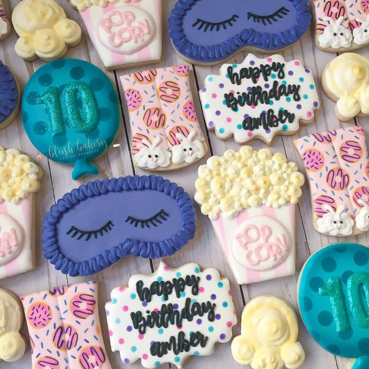 decorated cookies with the words happy birthday written on them are arranged in different shapes and colors