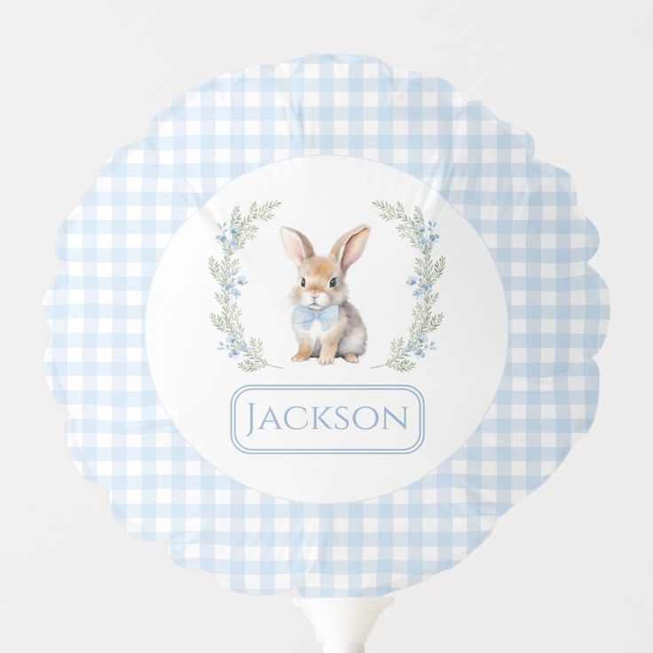 a blue and white gingham paper fan with a bunny on it's front