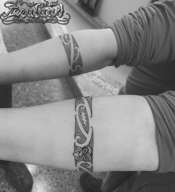 two people with matching tattoos on their arms