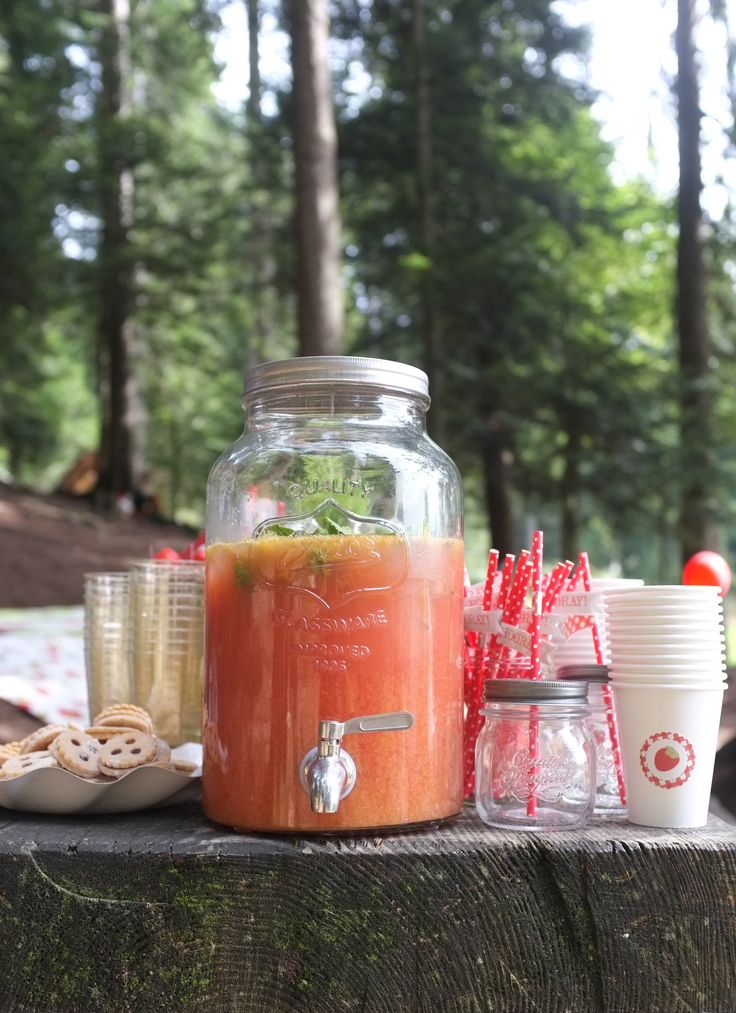 a jar filled with liquid sitting on top of a wooden table