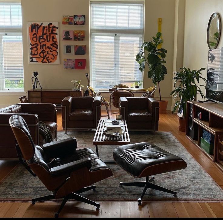 a living room filled with furniture and a flat screen tv on top of a hard wood floor