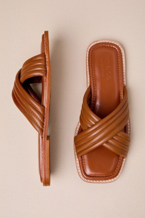 The Rag & Co Eura Tan Leather Slide Sandals will make you more than ready for sunshine and plenty of compliments! Smooth genuine leather shapes these chic sandals that feature a trendy square-toe bed and wide, crisscrossing vamp straps that boast a quilted-like effect. The simple slide-on design makes getting dressed easy and effortlessly cute! Available in whole sizes only. 0. 5" rubber heel. Cushioned insole. Rubber sole has nonskid markings. Genuine leather upper. Balance man made materials. Leather Sandals With Square Toe For Vacation, Trendy Brown Sandals With Square Toe, Trendy Brown Square Toe Sandals, Chic Vacation Sandals With Square Toe, Chic Square Toe Sandals For Vacation, Chic Sandals, Leather Slide Sandals, Leather Slides, Rubber Heels