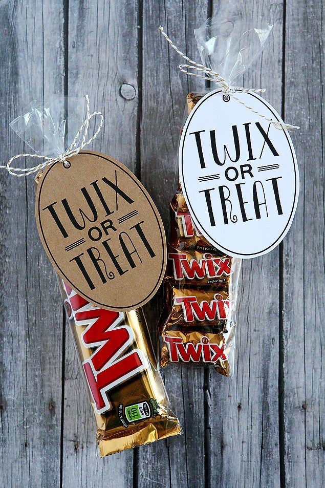 two candy bars tied up to each other with twin or treat stickers on them