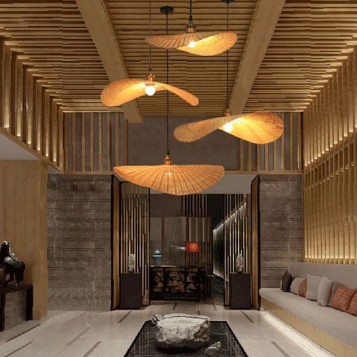 a living room filled with lots of furniture next to a wooden ceiling mounted light fixture