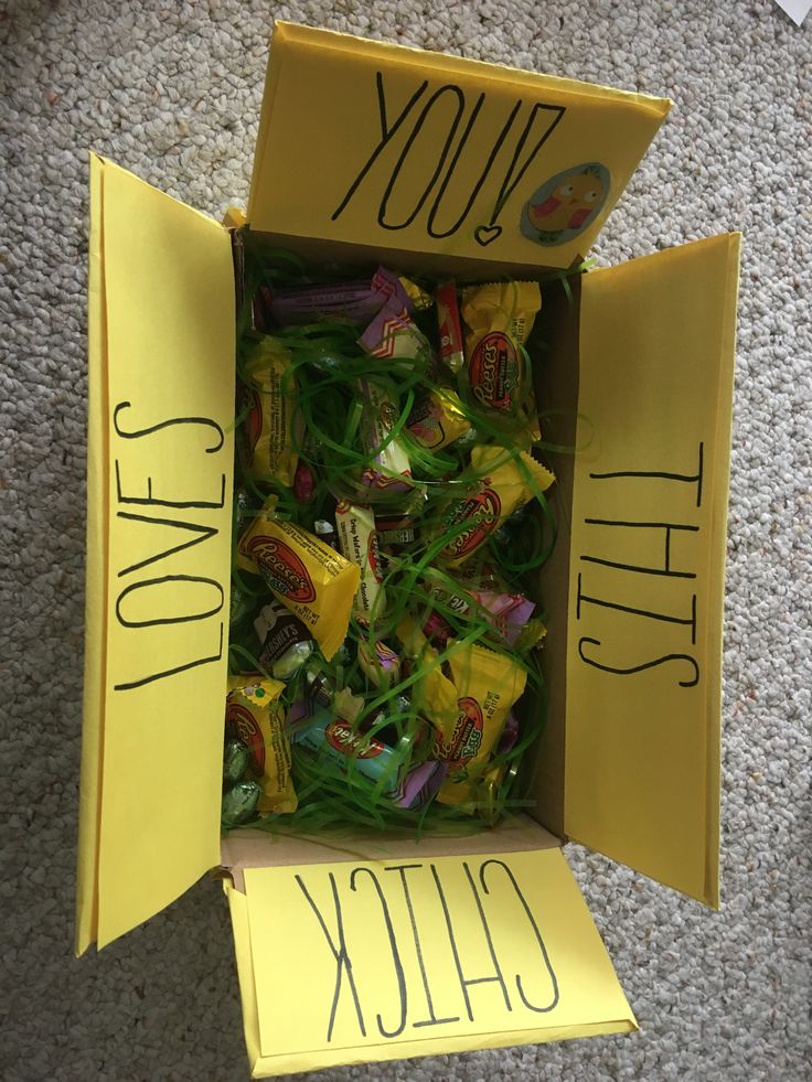 a yellow box filled with candy sitting on top of a floor